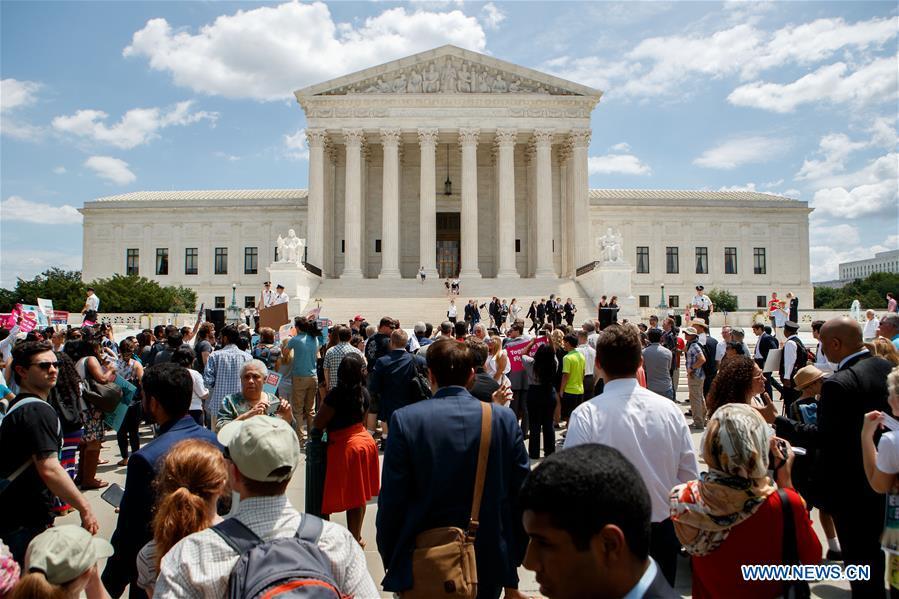 People gather to protest Supreme Court\'s ruling regarding Trump\'s travel ban in front the U.S. Supreme Court in Washington D.C., the United States, on June 26, 2018. U.S. Supreme Court on Tuesday ruled President Donald Trump\'s travel ban on several Muslim-majority countries is lawful. (Xinhua/Ting Shen)