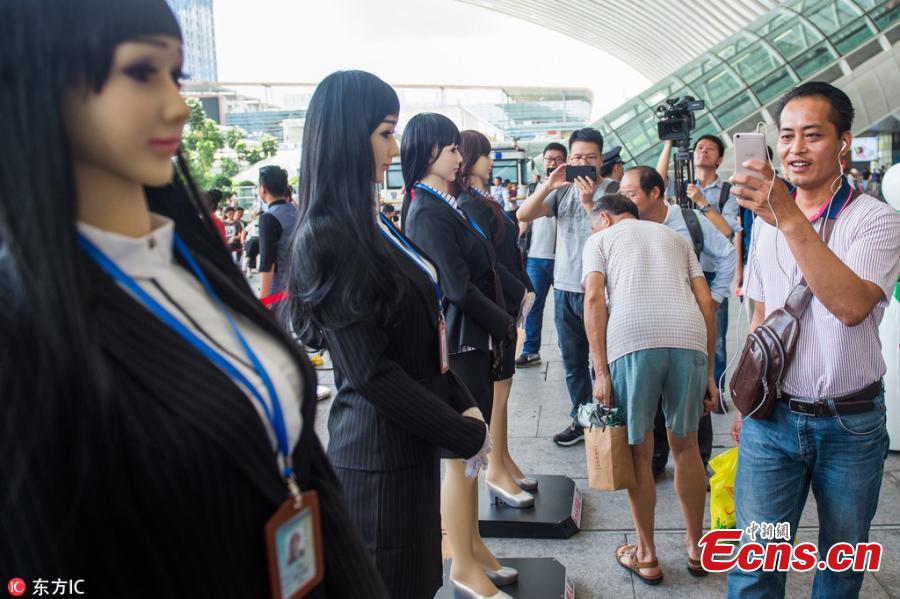 Humanoid robots are used to promote public awareness of drug abuse in an event to mark the International Day Against Drug Abuse and Illicit Trafficking at a railway station in Shenzhen City, South China\'s Guangdong Province, June 26, 2018. The six robots distributed brochures and interacted with visitors at the event, jointly organized by local police, an artificial intelligence association and a robot developer. (Photo/IC)
