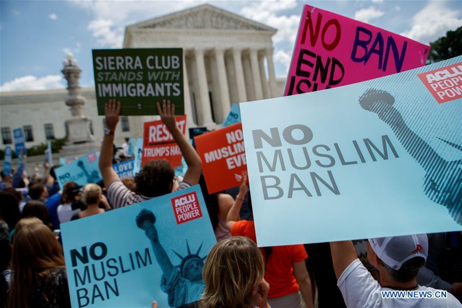 People gather to protest Supreme Court\'s ruling regarding Trump\'s travel ban in front the U.S. Supreme Court in Washington D.C., the United States, on June 26, 2018. U.S. Supreme Court on Tuesday ruled President Donald Trump\'s travel ban on several Muslim-majority countries is lawful. (Xinhua/Ting Shen)