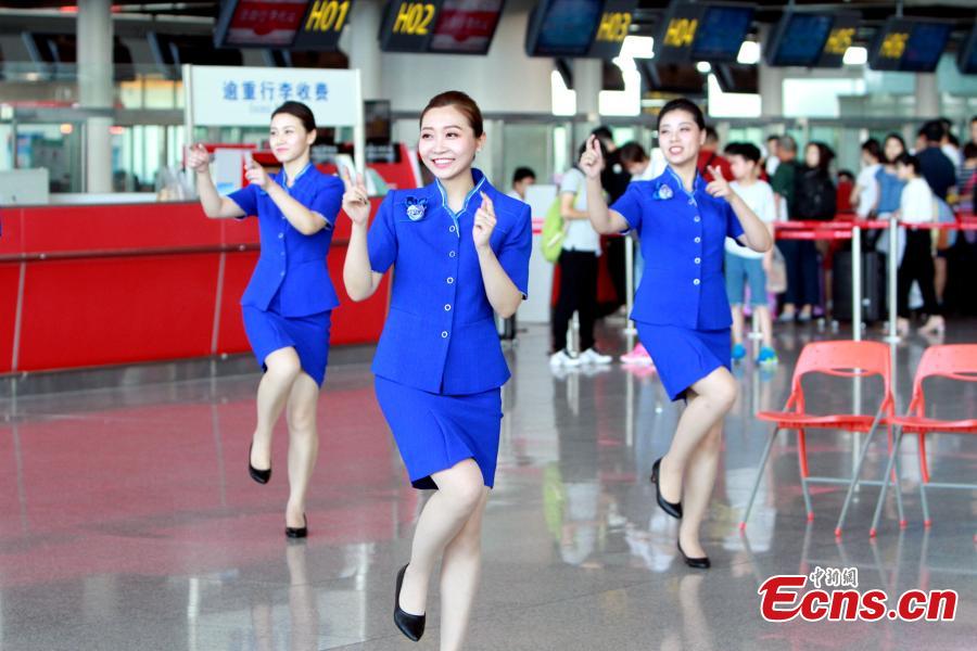 Staff members of the Tianjin Binhai International Airport stage a flash mob at the airport, June 28, 2018. (Photo/China News Service)