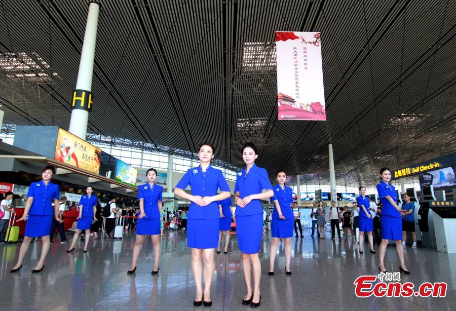 Staff members of the Tianjin Binhai International Airport show new uniforms at the airport, June 28, 2018. (Photo/China News Service)