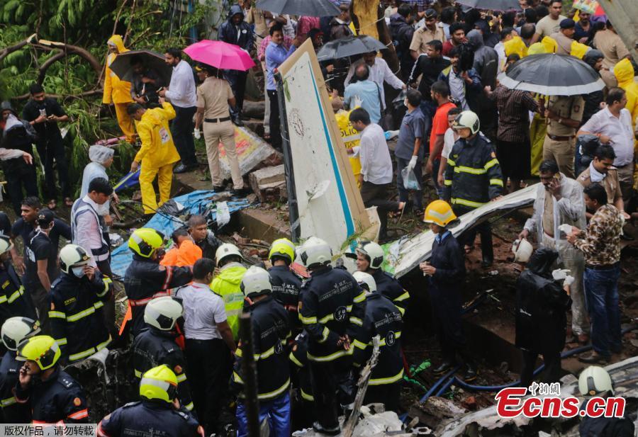 Rescuers stand amid the wreckage of a private chartered plane that crashed in Ghatkopar area, Mumbai, India, June 28, 2018. Five people including one person on the ground were killed. (Photo/Agencies)