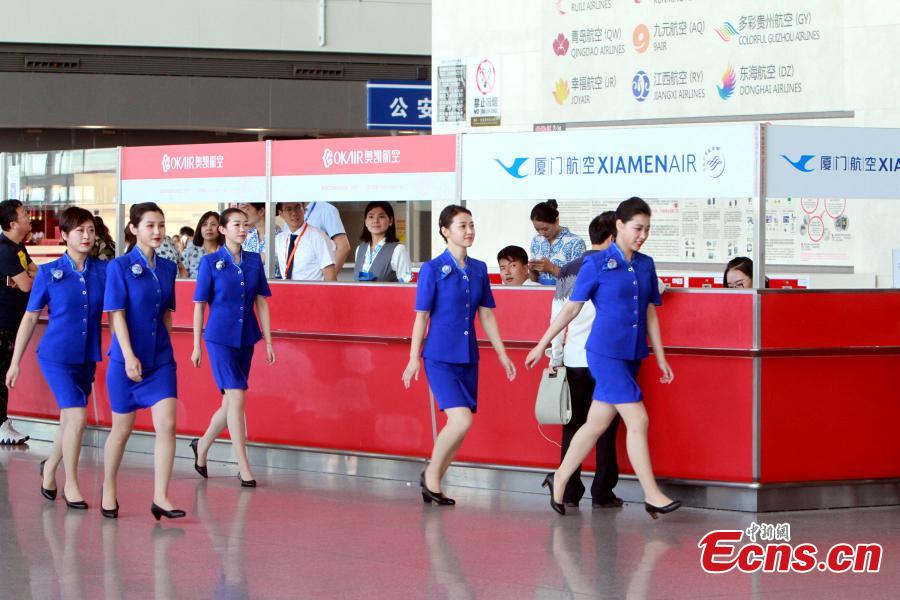 Staff members of the Tianjin Binhai International Airport show new uniforms at the airport, June 28, 2018. (Photo/China News Service)