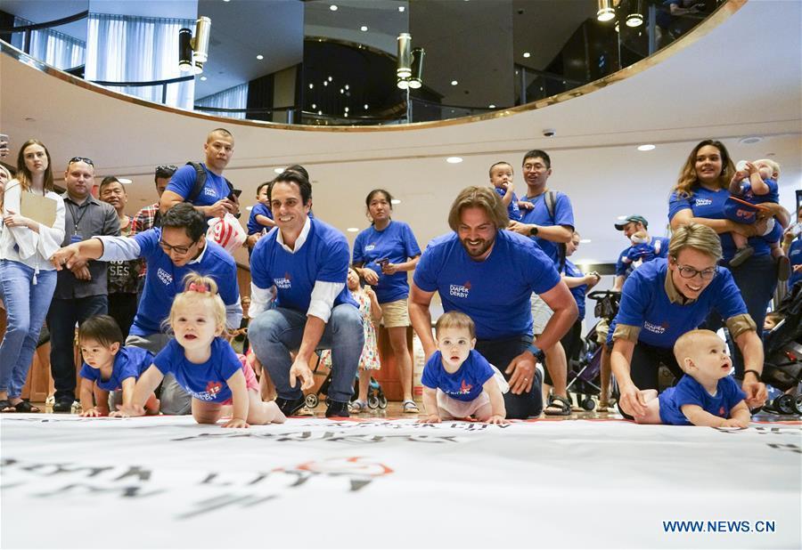 Babies participate in the Diaper Derby 2018 in New York, the United States, June 29, 2018. Diaper Derby 2018, a baby crawling contest, was held here on Friday. Around 30 babies competed to crawl across a 12-foot (3.66 meters) long mat. (Xinhua/Lin Bilin)