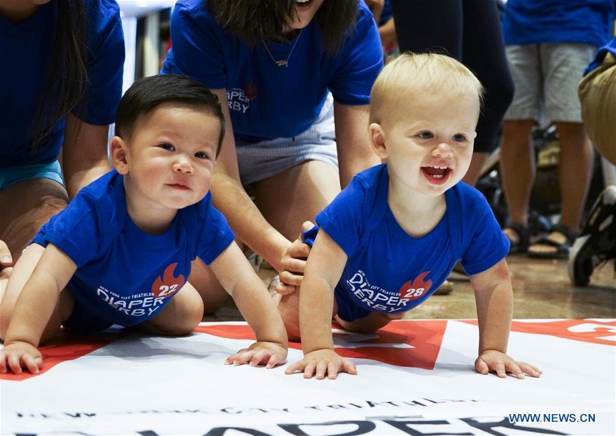 Babies participate in the Diaper Derby 2018 in New York, the United States, June 29, 2018. Diaper Derby 2018, a baby crawling contest, was held here on Friday. Around 30 babies competed to crawl across a 12-foot (3.66 meters) long mat. (Xinhua/Lin Bilin)
