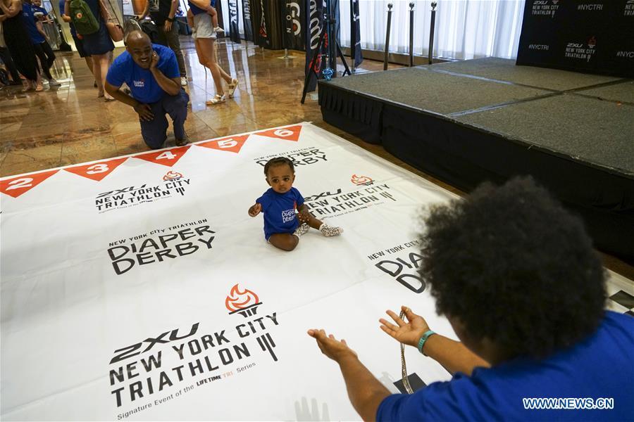 A baby participates in the Diaper Derby 2018 in New York, the United States, June 29, 2018. Diaper Derby 2018, a baby crawling contest, was held here on Friday. Around 30 babies competed to crawl across a 12-foot (3.66 meters) long mat. (Xinhua/Lin Bilin)