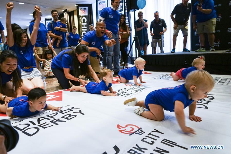 Babies participate in the Diaper Derby 2018 in New York, the United States, June 29, 2018. Diaper Derby 2018, a baby crawling contest, was held here on Friday. Around 30 babies competed to crawl across a 12-foot (3.66 meters) long mat. (Xinhua/Lin Bilin)