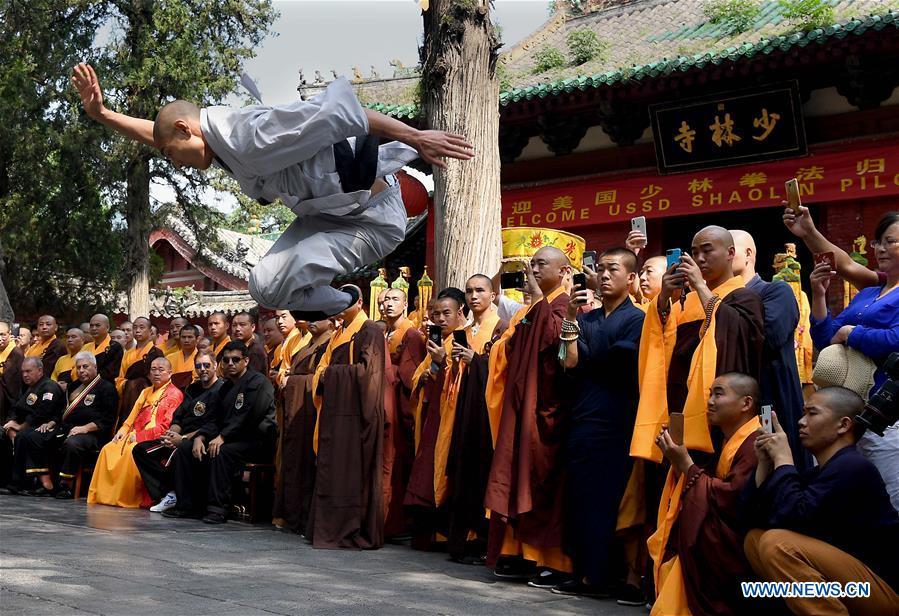 A monk performs martial arts at Shaolin Temple on the Mount Songshan, central China\'s Henan Province, July 1, 2018. Over 200 Kungfu enthusiasts from America made a trip to the Shaolin Temple and performed martial arts with local monks. (Xinhua/Li An)
