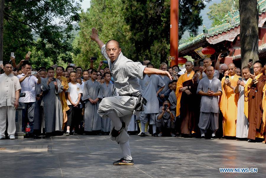 A monk performs martial arts at Shaolin Temple on the Mount Songshan, central China\'s Henan Province, July 1, 2018. Over 200 Kungfu enthusiasts from America made a trip to the Shaolin Temple and performed martial arts with local monks. (Xinhua/Li An)