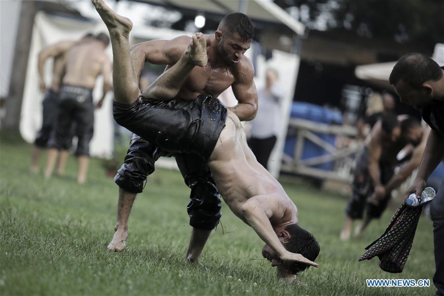Photo taken on June 30, 2018, shows wrestlers participate in traditional oil wrestling competition in the village of Sohos, Thessaloniki, Greece. (Xinhua/ Dimitris Tosidis)