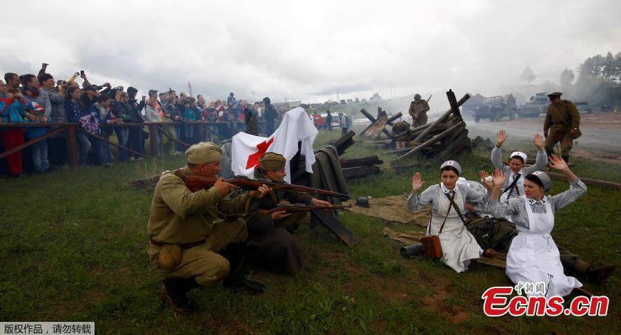 <?php echo strip_tags(addslashes(Military enthusiasts take part in a re-enactment of a World War II battle on the eve of Independence Day at the 