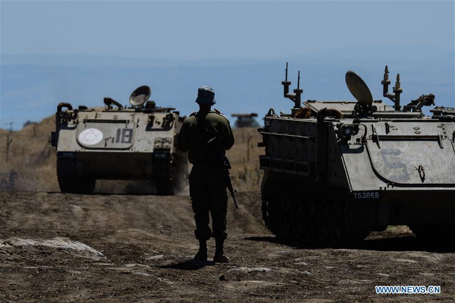 Israeli armored vehicles are seen near the ceasefire line with Syria on the Israeli-occupied Golan Heights on July 1, 2018. The Israel Defense Forces (IDF) deployed additional tanks and artillery on the Golan Heights. (Xinhua/Ayal Margolin-JINI)