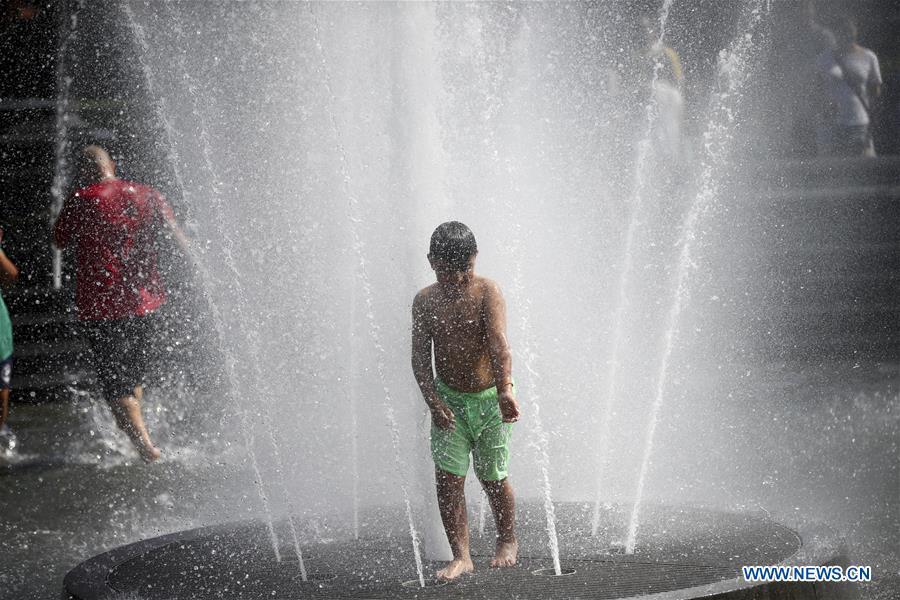 A boy cools himself at a fountain at Washington Square Park in New York City, the United States, on July 2, 2018. The highest temperature reached 35 degrees Celsius in New York City on Monday as a result of a prolonged heat wave. (Xinhua/Wang Ying)