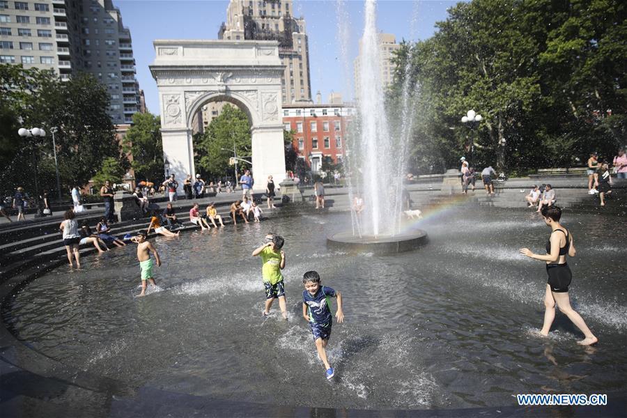 People cool themselves at a fountain at Washington Square Park in New York City, the United States, on July 2, 2018. The highest temperature reached 35 degrees Celsius in New York City on Monday as a result of a prolonged heat wave. (Xinhua/Wang Ying)
