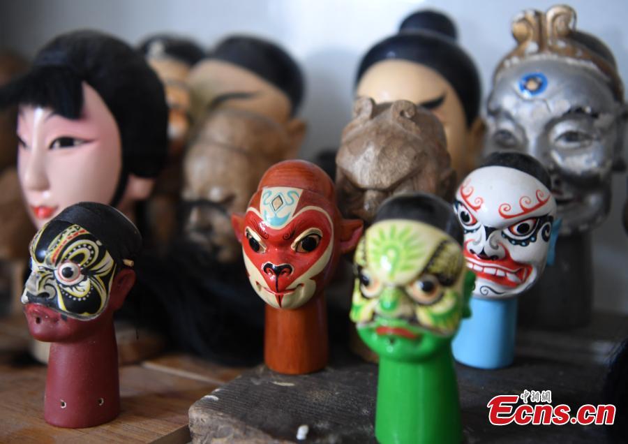 <?php echo strip_tags(addslashes(Folk artist Yang Yazhou shows his puppet head creations in his studio in Zhangzhou City, East China’s Fujian Province, July 1, 2018. Zhangzhou has a history of puppetry going back more than two thousand years. Yang represents the fifth generation of his family to be involved with Fuchun-style glove puppets show, an intangible cultural heritage. He began learning to carve puppet heads when he was nine years old, taught by several masters. Yang said it takes tens of steps to finish carving a puppet-head in about three days. Yang’s sister specializes in dressing the puppets, his brother in puppet performance. (Photo: China News Service/Zhang Bin))) ?>