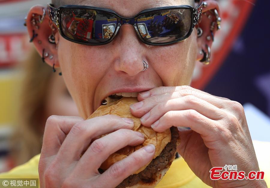 Molly Schuyler, the top-ranked competitive eater in the world, downs a burger in the 9th Annual Independence Burger Eating Championship at Z-Burger on July 3, 2018 in Washington, DC. Schuyler won the event by consuming 27 burgers in 10 minutes. (Photo/Agencies)