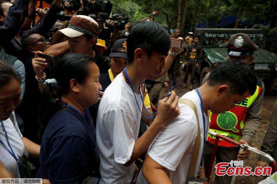 Family members are escorted by police on their way to enter the Tham Luang cave complex, as members of an under-16 soccer team and their coach have been found alive according to local media, in the northern province of Chiang Rai, Thailand, July 4, 2018. (Photo/Agencies)