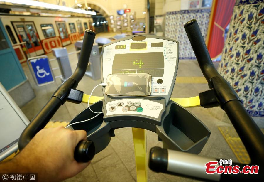 A man uses a bicycle pedal power generator which was installed by the IETT (Istanbul electric tramway and tunnel establishments) at the Tunnel railway station to charge his mobile phone in Istanbul, Turkey, July 05, 2018. (Photo/Agencies)