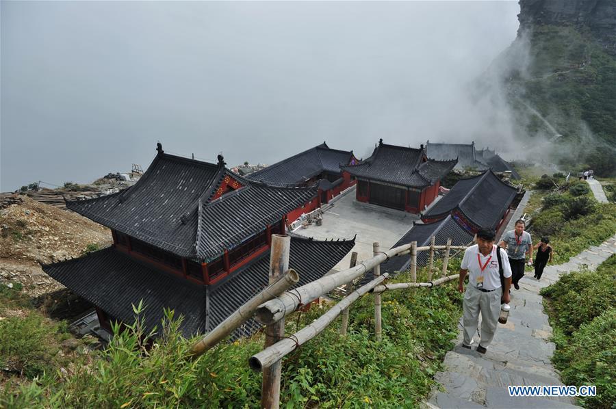 Tourists go sightseeing at the Mount Fanjingshan scenic spot in Tongren City, southwest China\'s Guizhou Province, Sept. 6, 2011. Mount Fanjingshan was inscribed on the World Heritage List on July 2, 2018 at the 42nd World Heritage Committee meeting in Bahrain. The ecosystem of Fanjingshan has preserved large numbers of ancient relict plants, rare and endangered creatures, as well as unique species. (Xinhua/Ou Dongqu)