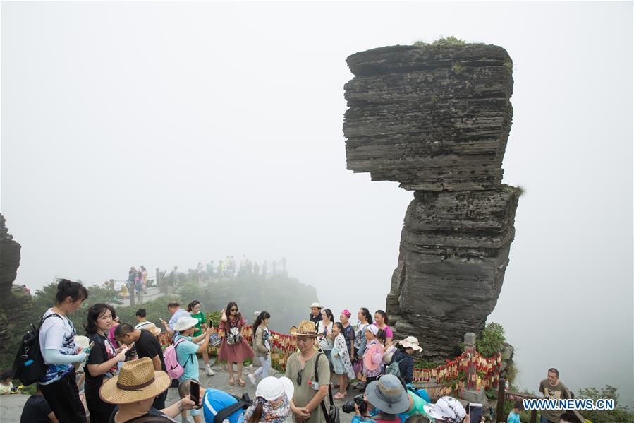<?php echo strip_tags(addslashes(Tourists go sightseeing at the Mount Fanjingshan scenic spot in Tongren City, southwest China's Guizhou Province, Aug. 7, 2017. Mount Fanjingshan was inscribed on the World Heritage List on July 2, 2018 at the 42nd World Heritage Committee meeting in Bahrain. The ecosystem of Fanjingshan has preserved large numbers of ancient relict plants, rare and endangered creatures, as well as unique species. (Xinhua/Yao Lei))) ?>