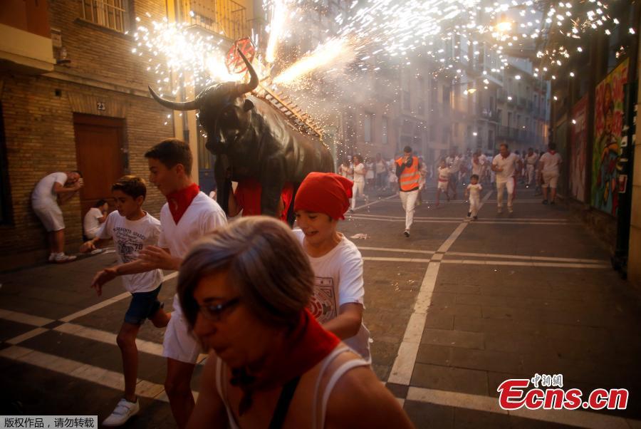 <?php echo strip_tags(addslashes(Revelers run from the Fire Bull, a man carrying a bull figure packed with fireworks, at the San Fermin festival in Pamplona, Spain July 8, 2018. (Photo/Agencies))) ?>