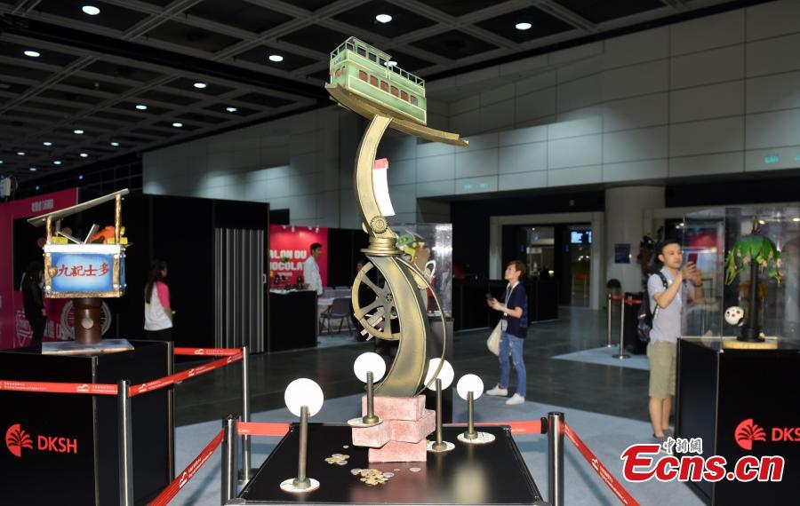Visitors look at chocolate creations at the first Salon du Chocolat in Hong Kong, July 6, 2018. Salon du Chocolat, one of the world’s biggest chocolate events, showcases chocolate sculptures inspired by Hong Kong culture and the Year of the Dog. Meanwhile, guests were also able to sample award-winning creations during a live pastry show. (Photo: China News Service/Zhang Wei)