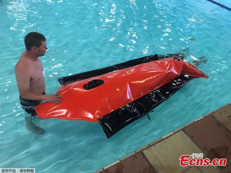 A diver tests the tiny kid-sized submarine in a pool in Los Angeles. Musk said the construction will be \