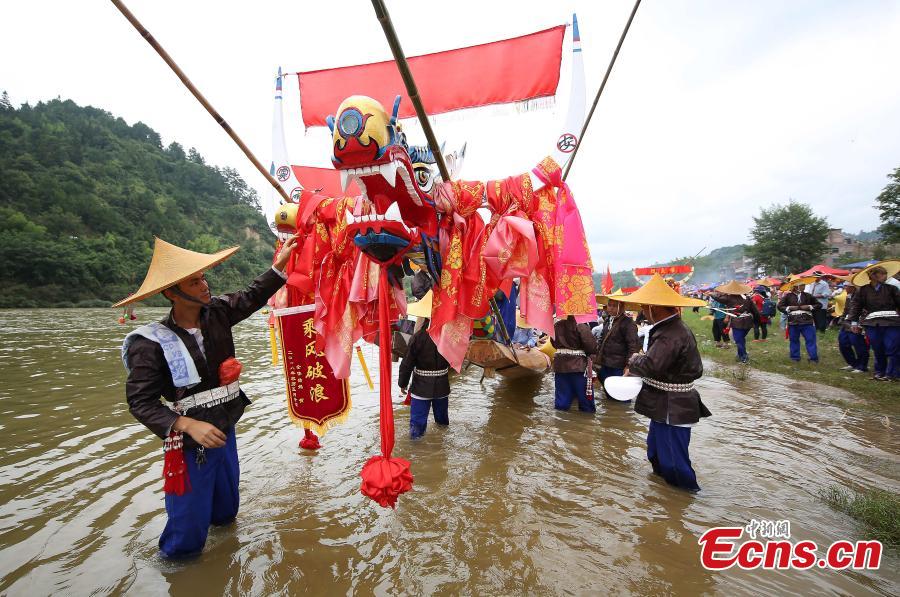 <?php echo strip_tags(addslashes(Miao people celebrate the dragon boat festival in Qingshui River, Taijiang County, Southwest China’s Guizhou Province, July 8, 2018. The dragon boat of the Miao is rather special. It is commonly made from a large fir or phoenix tree. Before the contest, villagers will offer chicken and duck to pray for luck and prosperity. The local festival was recognized as a national intangible cultural heritage in 2008. (Photo: China News Service/Huang Xiaohai))) ?>