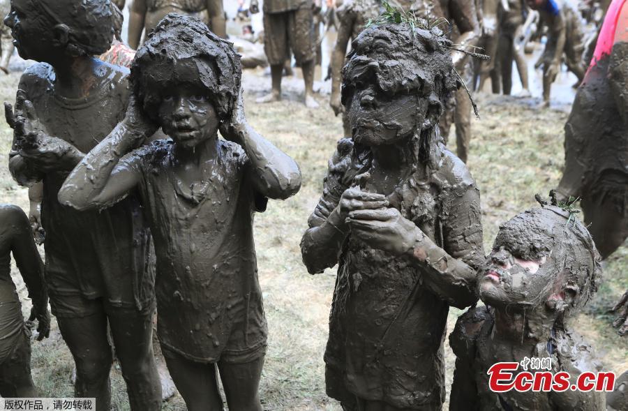 Girls line up to be judged Mud Day Queen during Mud Day at the Nankin Mills Park, July 10, 2018, in Westland, Mich. The annual day sponsored by the Wayne County Parks takes place in a 75\' x 150\' giant mud pit that gives children the opportunity to get down and dirty at one of the messiest playgrounds Southeast Michigan has ever seen.(Photo/Agencies)