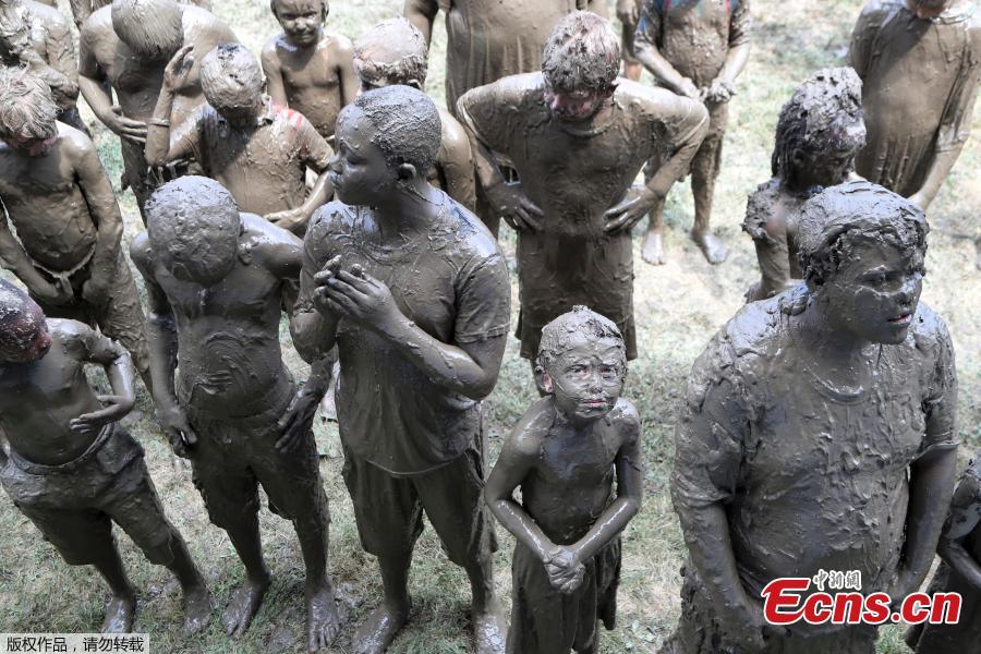 Boys line up to be judged Mud Day King during Mud Day at the Nankin Mills Park, July 10, 2018, in Westland, Mich. The annual day sponsored by the Wayne County Parks takes place in a 75\' x 150\' giant mud pit that gives children the opportunity to get down and dirty at one of the messiest playgrounds Southeast Michigan has ever seen. (Photo/Agencies)