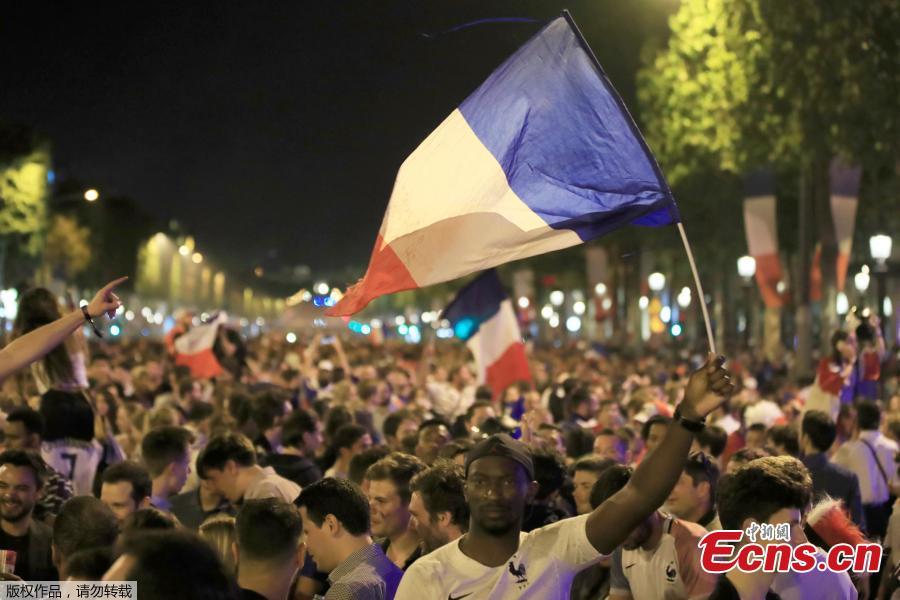 France fans react on the Champs-Elysees in Paris, France, July 10, after defeating Belgium 1-0 in their World Cup semi-final match in St Petersburg. It means the 1998 World Cup winners will play either England or Croatia in the final on Sunday. (Photo/Agencies)