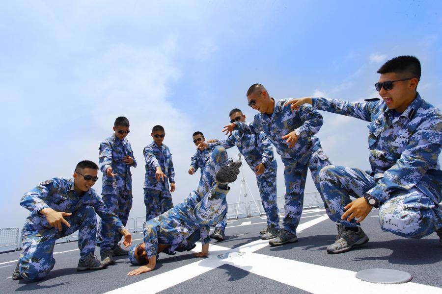 Students from Dalian Naval Academy take a graduation photo on the deck of a training vessel during their graduation practice in June 2018. (Photo provided to chinadaily.com.cn)