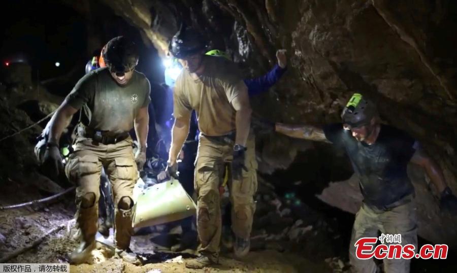 This undated image from video released via the Thai NavySEAL Facebook Page on July 11, 2018, shows rescuers hold an evacuated boy inside the Tham Luang Nang Non cave in Mae Sai, Chiang Rai province, in northern Thailand. A daring rescue mission in the treacherous confines of a flooded cave in northern Thailand has saved all 12 boys and their soccer coach who were trapped deep within the labyrinth, ending a grueling 18-day ordeal that claimed the life of an experienced volunteer diver and riveted people around the world. (Photo/Agencies)