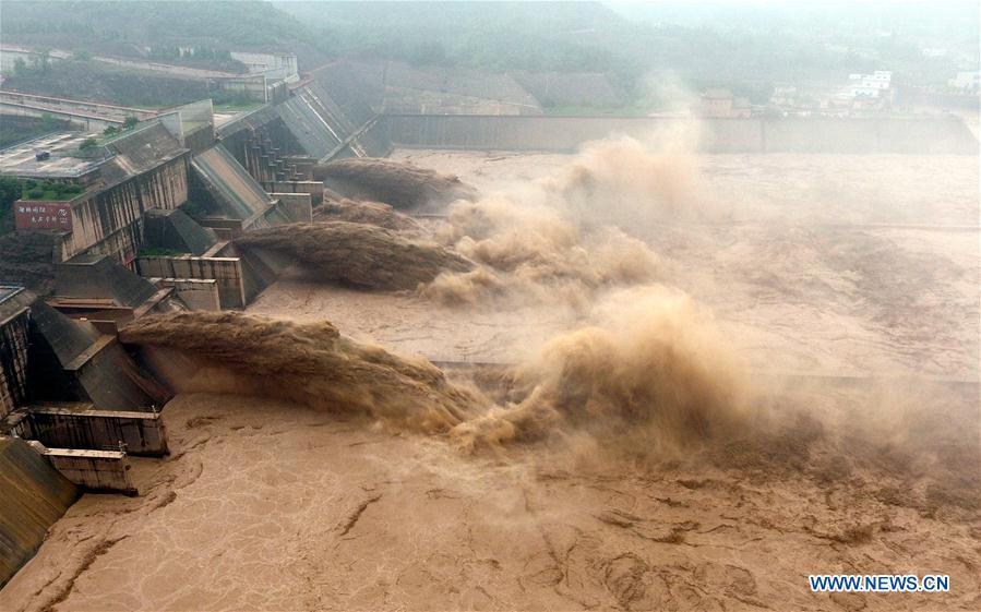 <?php echo strip_tags(addslashes(Aerial photo taken on July 11, 2018 shows water gushing out from the Xiaolangdi Reservoir on the Yellow River in central China's Henan Province. (Xinhua/Li Jianan))) ?>