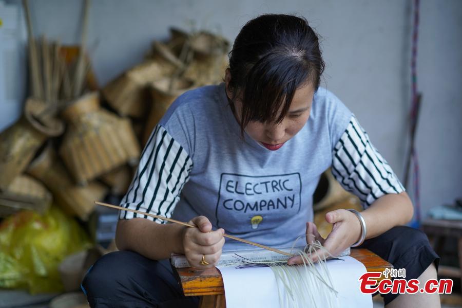 Yang Dujuan weaves a QR code using bamboo strips in Sansui County, Southwest China’s Guizhou Province, July 11, 2018. A former migrant worker, Yang began to lead other villagers to make bamboo creations in 2014, trained more than 300 locals, and has now reached annual sales surpassing one million yuan ($150,000). In 2018, she began offering bamboo strips made into QR codes for clients, a creative combination of traditional bamboo weaving and the emerging popularity of codes that smartphone users can scan to access rich information. Her creation priced at 200 yuan for products was popular online. (Photo: China News Service/He Junyi)