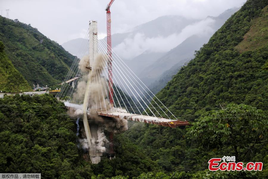 <?php echo strip_tags(addslashes(A view of Chirajara bridge at the Villavicencio city is seen during the controlled destruction, on July 11, 2018 in Bogota, Colombia. Implosion for the remains in the south part of the cable bridge was carried out with explosives. The bridge that was under construction was collapsed on January. Nine construction workers were died and eight were injured. (Photo/Agencies))) ?>
