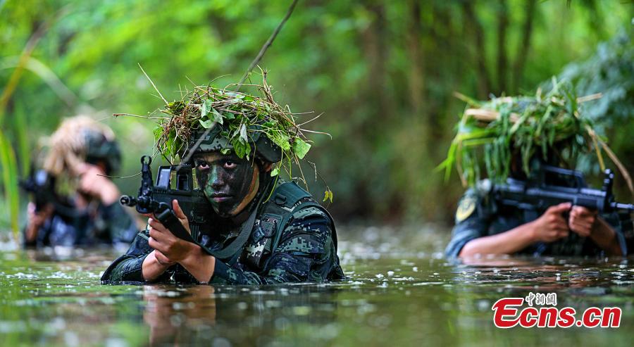 Armed police officers receive intensive training as temperatures hit 35 degrees centigrade in Xuancheng City, East China’s Anhui Province, July 12, 2018. The one-week training included skills in search and rescue in a mountain setting, shooting, and swimming across a river in combat gear. (Photo: China News Service/Ye Jingwen)