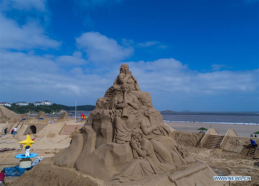 This aerial photo taken on July 12, 2018 shows a half-finished sand sculpture work to be shown at the upcoming 2018 Zhoushan International Sand Sculpture Festival in Zhoushan, east China\'s Zhejiang Province. The works of over 30 sand sculptors worldwide will be officially made available to public visitors on July 21. (Xinhua/Xu Yu)