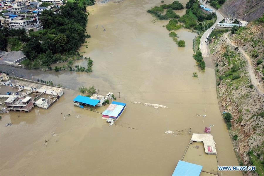 Aerial photo taken on July 14, 2018 shows the flooded Nanyu Township of Zhouqu County, northwest China\'s Gansu Province. A landslide occurred on Thursday at Nanyu Township of Zhouqu County due to continuous rainstorms. Rock and mud fell from mountain into the Bailong River, causing flooding in low-lying areas in neighboring Nanyi Village and Naner Village. No casualties have been reported and relief work is ongoing. (Xinhua/Fan Peishen)
