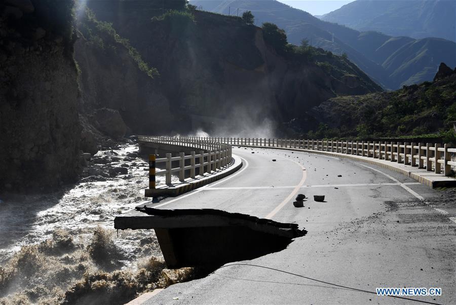 Photo taken on July 13, 2018 shows a damaged road in Nanyu Township of Zhouqu County, northwest China\'s Gansu Province. A landslide occurred on Thursday at Nanyu Township of Zhouqu County due to continuous rainstorms. Rock and mud fell from mountain into the Bailong River, causing flooding in low-lying areas in neighboring Nanyi Village and Naner Village. No casualties have been reported and relief work is ongoing. (Xinhua/Fan Peishen)