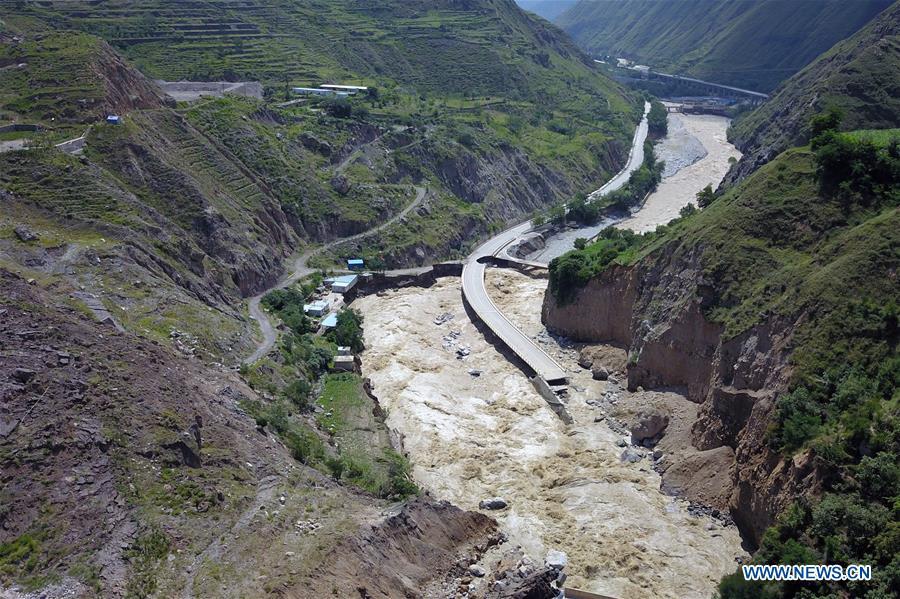 Photo taken on July 14, 2018 shows an inundated road in Nanyu Township of Zhouqu County, northwest China\'s Gansu Province. A landslide occurred on Thursday at Nanyu Township of Zhouqu County due to continuous rainstorms. Rock and mud fell from mountain into the Bailong River, causing flooding in low-lying areas in neighboring Nanyi Village and Naner Village. No casualties have been reported and relief work is ongoing. (Xinhua/Fan Peishen)