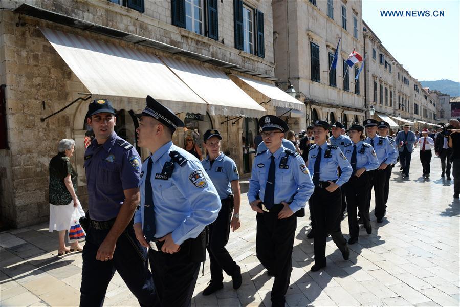 <?php echo strip_tags(addslashes(Chinese and Croatian police officers patrol after the launching ceremony of joint police patrol between China and Croatia in the Old Town of Dubrovnik, Croatia, on July 15, 2018. Six uniformed Chinese police officers started joint patrol with their Croatian counterparts here on Sunday. (Xinhua/Gao Lei))) ?>