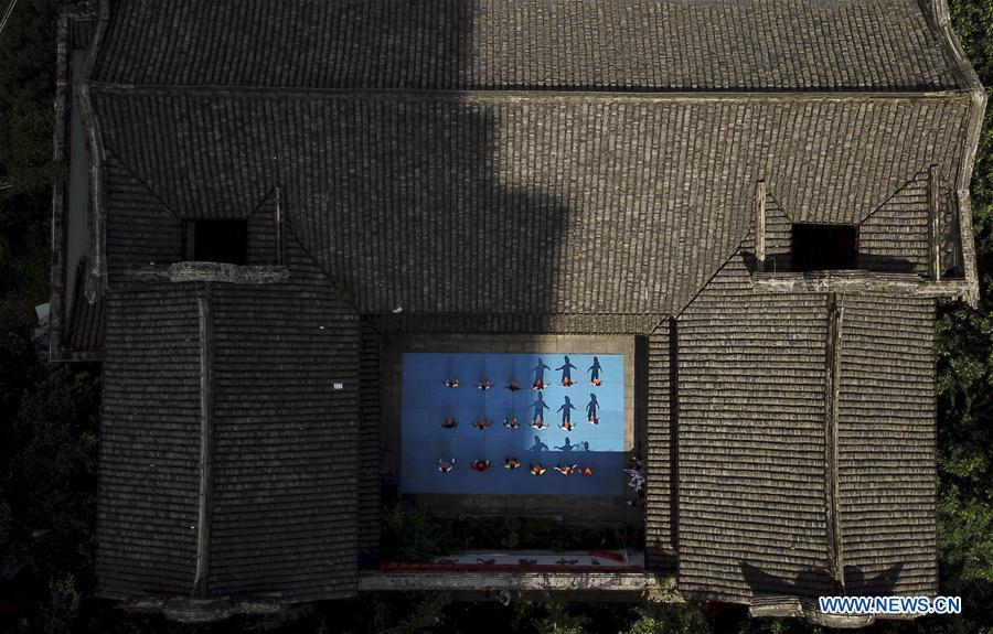 <?php echo strip_tags(addslashes(Aerial photo taken on July 14, 2018 shows children practising martial arts at Wenzhou Wushu Museum in Wenzhou, east China's Zhejiang Province. More than 120 children visited the museum on Sunday to learn about martial arts. (Xinhua/Su Qiaojiang))) ?>