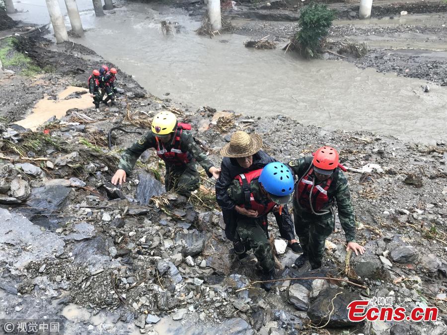 Rescuers help people affected by heavy rain and floods in Lueyang County, Northwest China’s Shaanxi Province. Six hours of heavy rain on July 13 and 14 caused landslides in the county, cutting off power and telecommunication and transportation links in many areas, and causing a direct economic loss of 193 million yuan ($28.8 million). Hundreds of firefighters and police officers, including armed police, have joined search and rescue efforts. Some police officers had to walk on foot for 57 kilometers. (Photo/VCG)