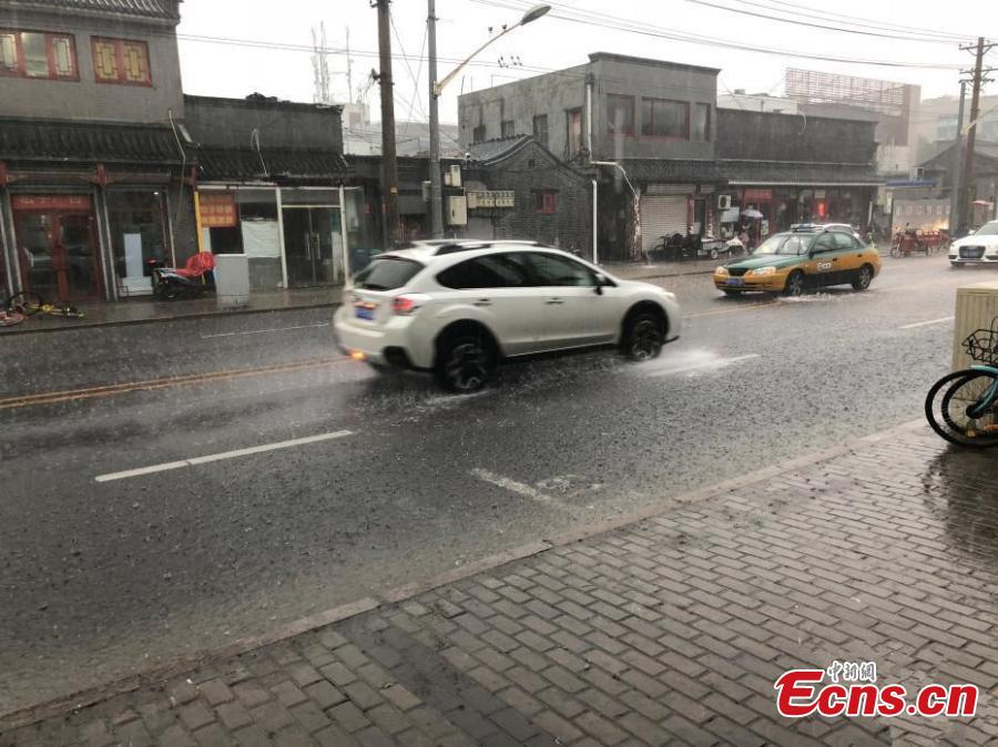 <?php echo strip_tags(addslashes(Vehicles drive during a downpour in Xicheng district of Beijing, on July 17, 2018. Areas of Beijing saw flooding after several days of rain. (Photo: China News Service/ Zhang Kaixin))) ?>