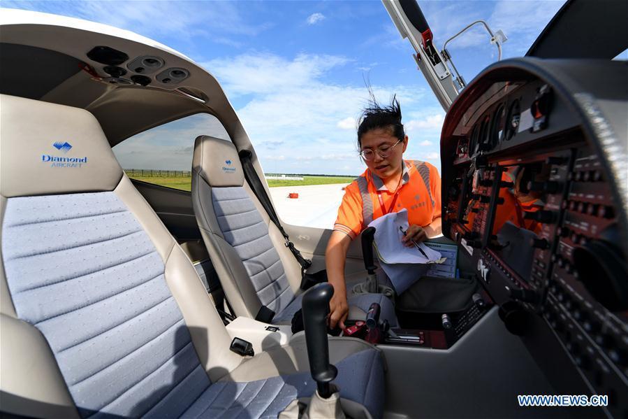 <?php echo strip_tags(addslashes(Deng Yun checks an aircraft at the Chagan Lake airport in Songyuan, northeast China's Jilin Province, July 17, 2018. Deng was born in 1991. She is an aircraft maintenance technician of an aviation academy in Jilin. The young female engineer and other nine colleagues are in charge of training plane maintenance at the airport. To ensure the flight safety, they need to check more than 100 items before a plane takes off. (Xinhua/Zhang Nan))) ?>