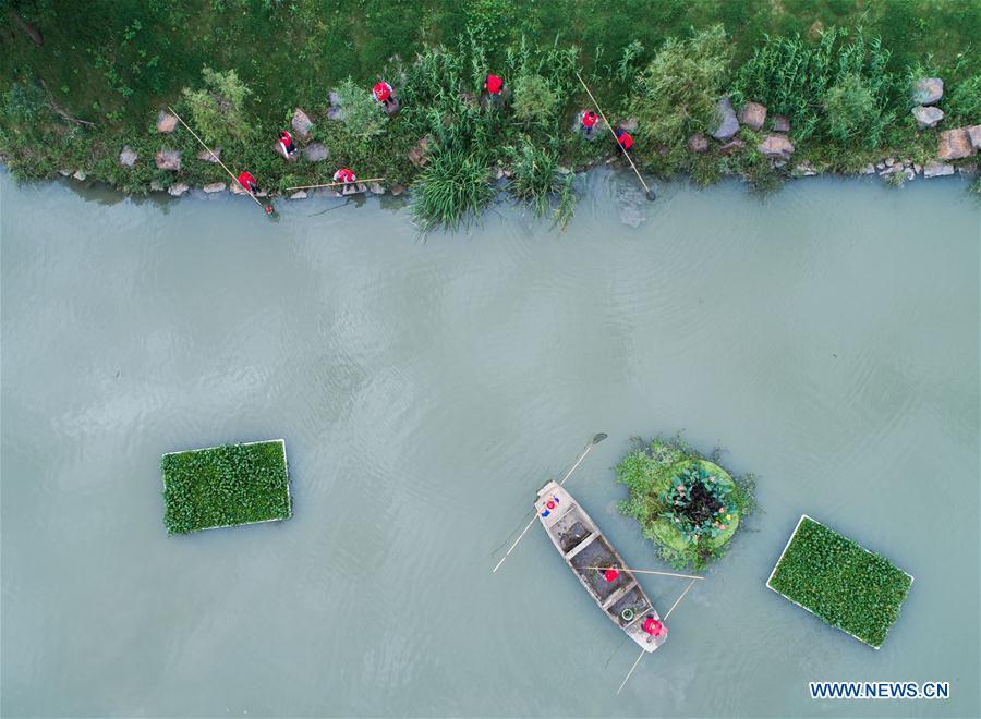 A river chief and sanitation workers patrol in Changxing County of east China\'s Zhejiang Province, Oct. 13, 2017. China has rolled out its river chief scheme nationwide ahead of schedule amid efforts to combat water pollution, a senior official said Tuesday. As of the end of June, more than 1.06 million river chiefs have been appointed at various levels nationwide, and six mechanisms have been set up to facilitate their work, Minister of Water Resources E Jingping told a press conference. (Xinhua/Xu Yu)
