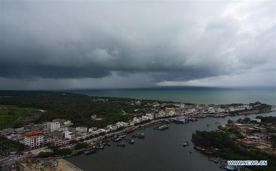 Fishing boats berth at a harbor in Qionghai, south China\'s Hainan Province, July 17, 2018. Ferry services on the Qiongzhou Strait in south China have been halted as of Tuesday afternoon as a typhoon is fast approaching the southern provinces of Hainan and Guangdong, local authorities have said. Son-Tinh, the ninth typhoon this year, is expected to make landfall in Hainan and Guangdong on Wednesday morning, according to China\'s National Meteorological Center. (Xinhua/Yang Guanyu)