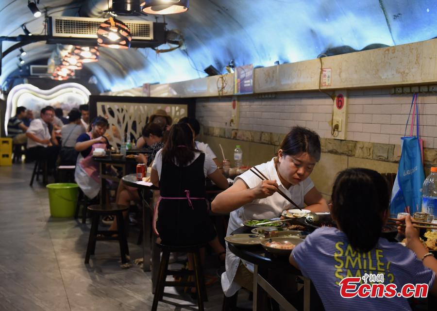 <?php echo strip_tags(addslashes(A popular hot pot restaurant inside a former air-raid shelter in Southwest China’s Chongqing Municipality, July 17, 2018. Authorities in Chongqing have allowed for the development of air-raid shelters, and they have been converted into wine cellars, restaurants and gas stations. The venues become especially popular in summer as it’s usually cool inside. (Photo: China News Service/Zhou Yi))) ?>