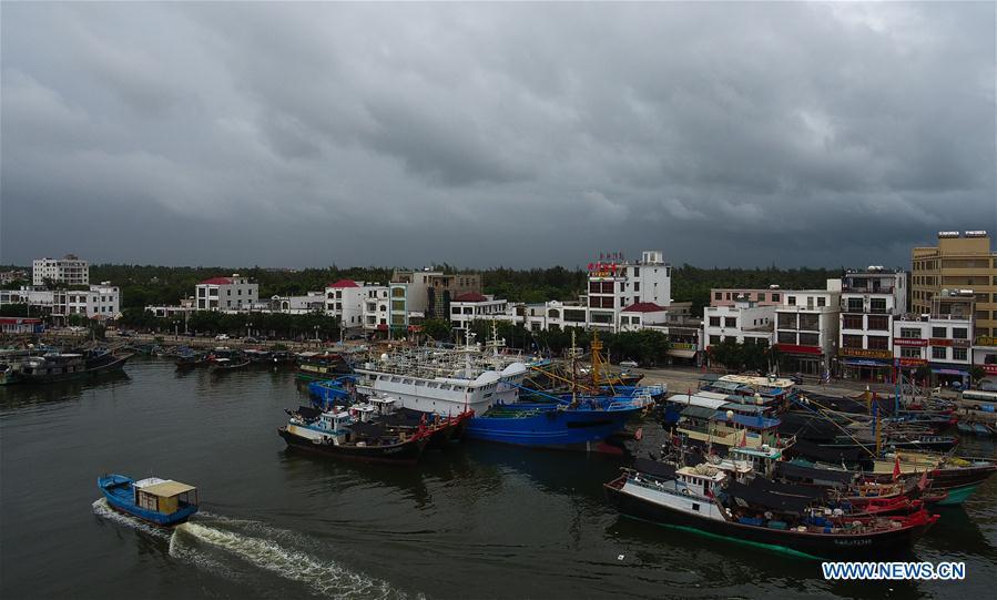 A fishing boat sails back to a harbor in Qionghai, south China\'s Hainan Province, July 17, 2018. Ferry services on the Qiongzhou Strait in south China have been halted as of Tuesday afternoon as a typhoon is fast approaching the southern provinces of Hainan and Guangdong, local authorities have said. Son-Tinh, the ninth typhoon this year, is expected to make landfall in Hainan and Guangdong on Wednesday morning, according to China\'s National Meteorological Center. (Xinhua/Yang Guanyu)